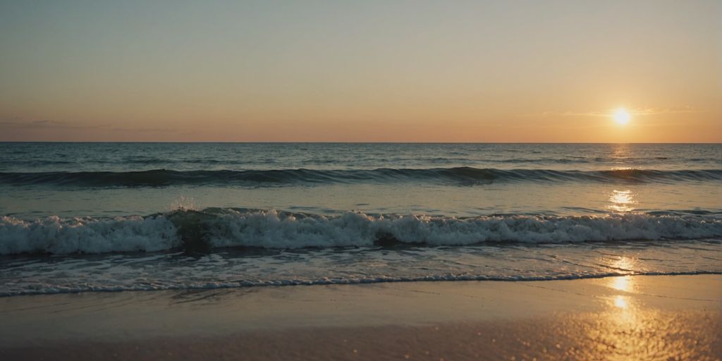 Peaceful beach at sunset with gentle waves.